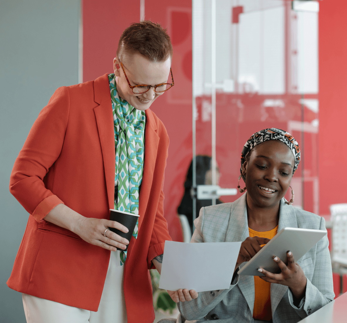 Image of two people reviewing a tablet in an office.