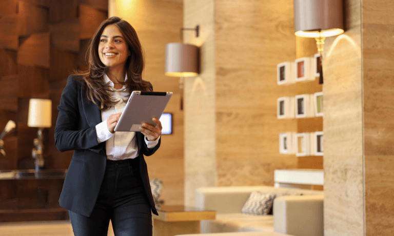 Hotels employee holding a tablet.
